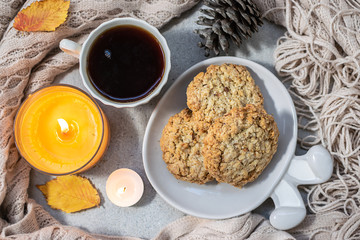 Cozy evening at home with hot aromatic tea, sweet homemade cookies, candles and autumn decor. Hygge home interior.
