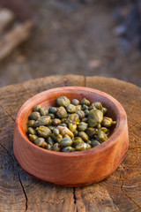 caper in a wood bowl