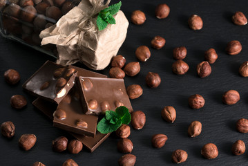 hazelnuts b chocolate on black background