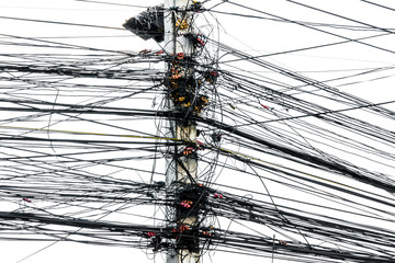 Messy chaos of cables with wires on electric pole on white background,The many Electric wire on the...
