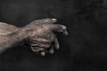 Senior old hands and arms.fingers and nails with veins. wrinkled skin of aged person. aging process.hand dirty of worker after working on dark background