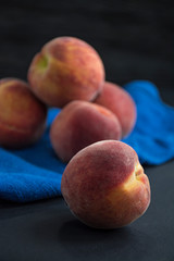 Peaches on a dark background. View from above. Space for text.