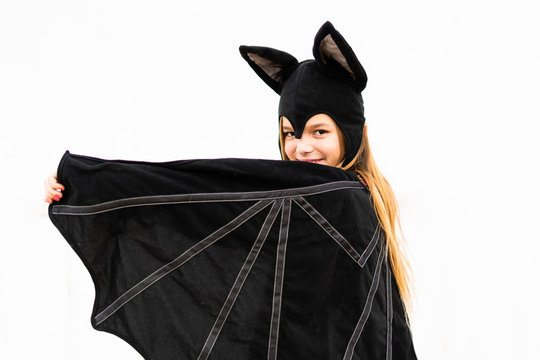 Portrait of girl in bat costume spreading wings