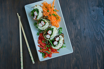 Zucchini roll with crab sticks, eggs and spinach. Delicious appetizer. View from above. Space for text.