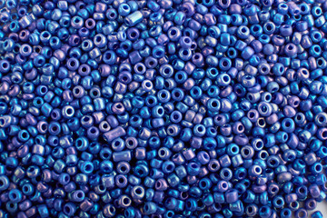 Multi-colored beads.Colorful beads on a wooden surface.It is used in finishing fashion...