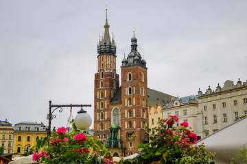 Krakow, Poland - May 21, 2019: View of flowers in the foreground, in the background the church is out of focus.