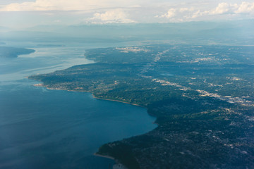 Western Washington coast seen from airplane, Puget Sound featured. Seattle in background.