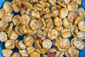 Heap of fried soy tortillas with vegetables in local street market in Thailand, closeup