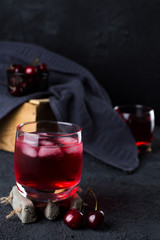 cherry drink in a low key setting  with whole cherries 