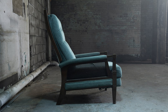 Side view of blue velvet armchair in warehouse