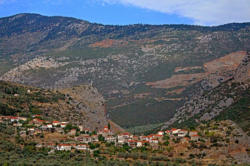 Fototapeta na wymiar The picturesque village stretches in the valley among Parnassus mountains near Thermopylae, Greece
