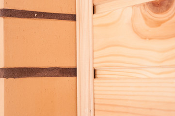 The combination of beige decorative brick with pine clapboard in the interior