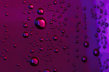 beautiful vials of air in water on a multi-colored background.The texture of water on the glass