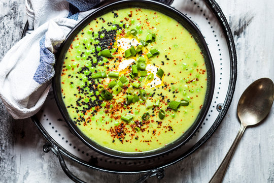 Bowl of Fresh green pea soup with spring onions