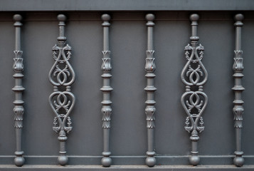 Fototapeta na wymiar Decorative ornamental cast iron fence, gray, large space for text, background or backdrop graphic element.