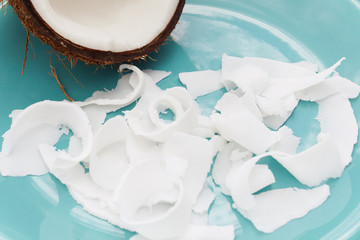 Fresh coconut on a blue plate