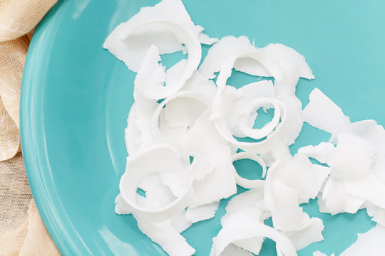 Fresh coconut on a blue plate