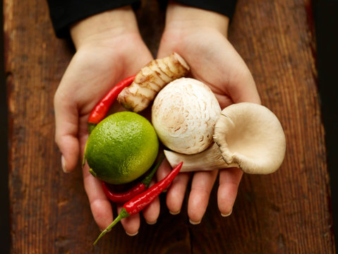 Ingredients for Tom Kha Gai soup in hands