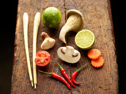 Ingredients for Asian Tom Kha Gai soup on wooden chopping board