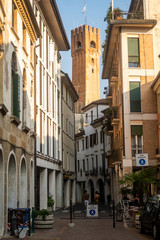 Fototapeta na wymiar Alley in Treviso, with Battistero di San Giovanni church as backdrop. Italy