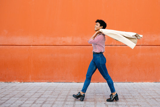 Side view of businesswoman walking on footpath