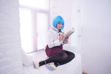 pretty plus size girl in blue wig have many dreams with her diary alone sitting on white windowsill