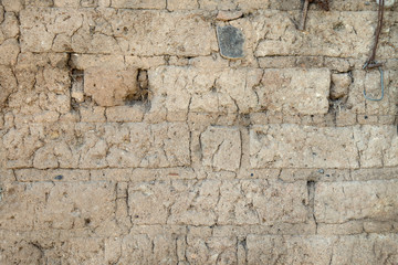 Old adobe brick wall. Texture background of an adobe close-up