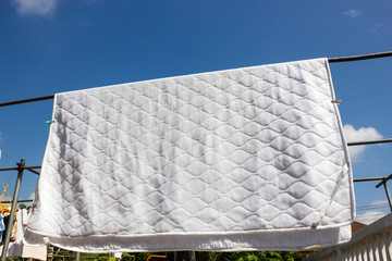 Clean bedding hanging to dry. Laundry background.