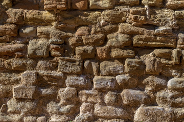 Background of the ancient stone wall of the castle in Spain.