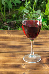 Glass of red wine on rusty wooden table