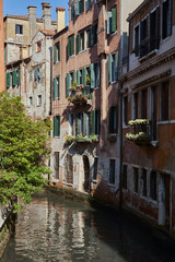 Traditional narrow canal in Venice, Italy.