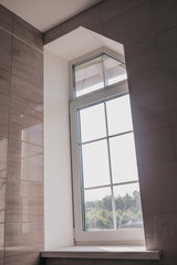 Narrow vertical window in the house - window in the toilet and bathroom - extra light - saving on electricity