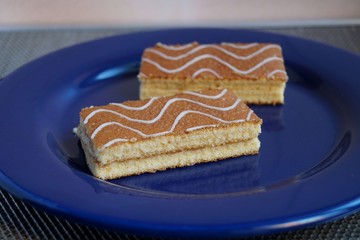 Two pieces of sponge cake on a blue plate