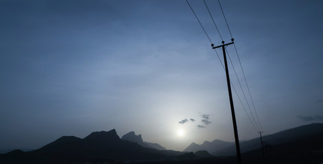 Sunset and electricity poles