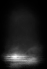 Wet asphalt, reflection of neon lights, a searchlight, smoke. Abstract light in a dark empty street...