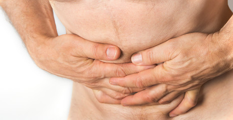 Fototapeta premium Man holding his belly. Stomach and indigestion problem