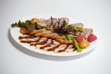 sliced meat on a white plate