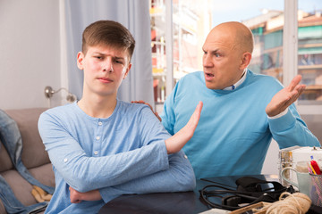 Son making stop gesture to father