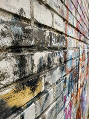 white brick wall in multi-colored paints