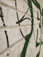 white brick wall with paint strokes