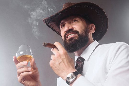 confident bearded man smoking cigar