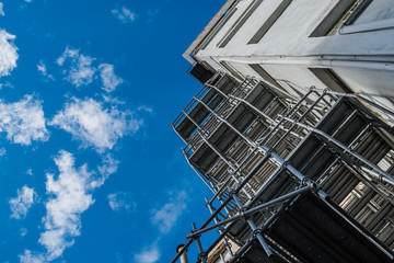 Building perspective and metallic scaffolding under blue sky