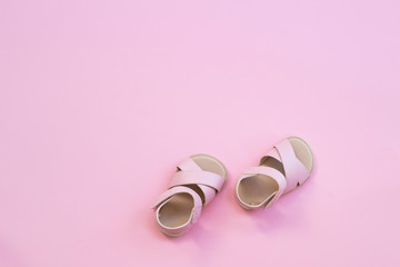 Baby shoes on a pink background