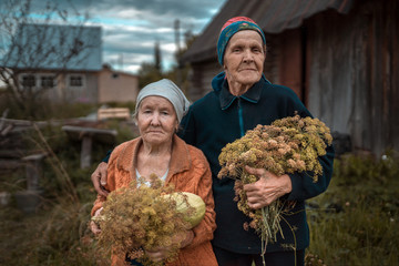 Portrait of senior women with dill herbs standing outdoors
