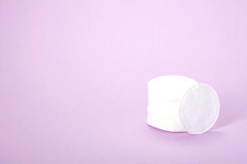 Cosmetic cotton pads. A stack of cotton pads on a delicate pink background. spa. close-up