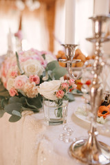 Wedding decoration of the Banquet table. Fresh flowers in vases and compositions in the wedding decor