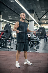 Fototapeta na wymiar Handsome strong bald athletic fitness men pumping up arm muscles workout barbell curl fitness concept background - muscular bodybuilder man doing bodybuilding biceps exercises in gym.
