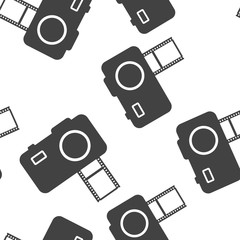 Vector illustration of a digital camera with film. Retro camera icon seamless pattern on a white background.