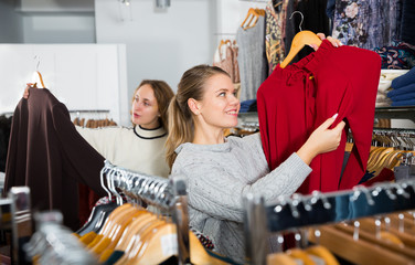 Women choosing new blouse