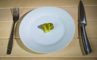 Vegetarian vegetables: broccoli, Brussels sprouts, cauliflower, carrots and green beans on a white plate and blue background. Selective focus